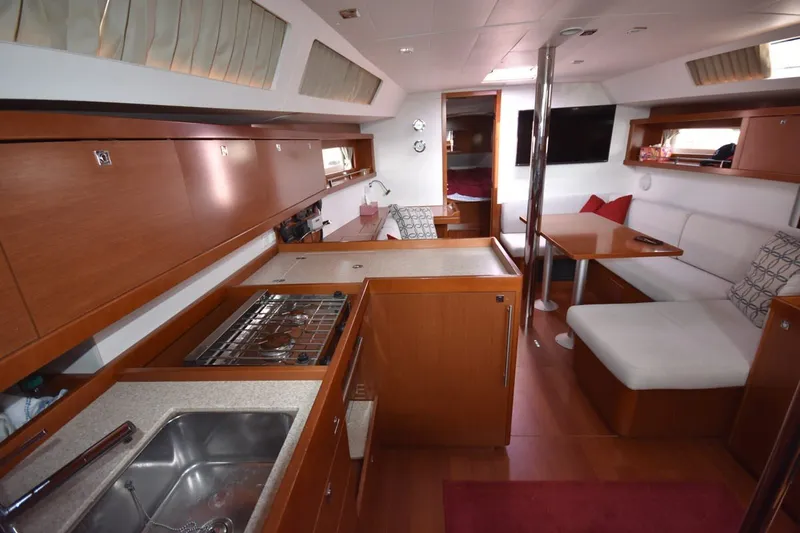 Slide: The Image of Interior of 2012 Beneteau Oceanis 41.1 yacht, featuring modern kitchen and cozy seating area. - 46