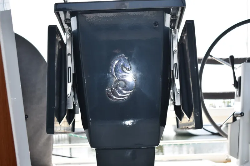 Slide: The Image of Close-up of Beneteau Oceanis 41.1 yacht helm, featuring a seahorse emblem. - 60