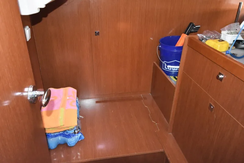 Slide: The Image of Interior of 2012 Beneteau Oceanis 41.1 yacht with wooden cabinetry and storage items. - 48