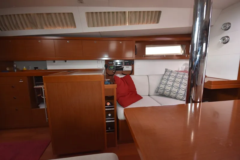 Slide: The Image of Interior of 2012 Beneteau Oceanis 41.1 yacht, featuring elegant wood cabinetry and cozy seating. - 39