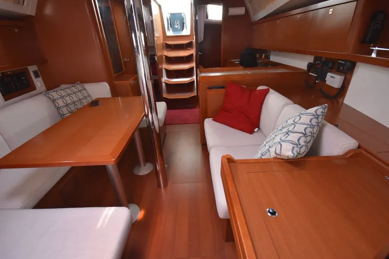 Slide: The Image of Interior of 2012 Beneteau Oceanis 41.1 yacht with wooden furnishings and cozy seating. - 42