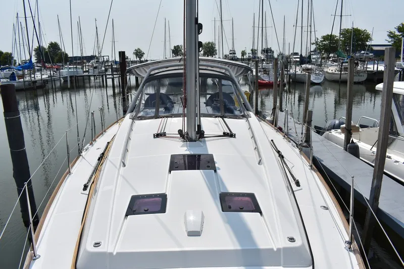 Slide: The Image of 2012 Beneteau Oceanis 41.1 sailboat docked in a marina, surrounded by other boats. - 25