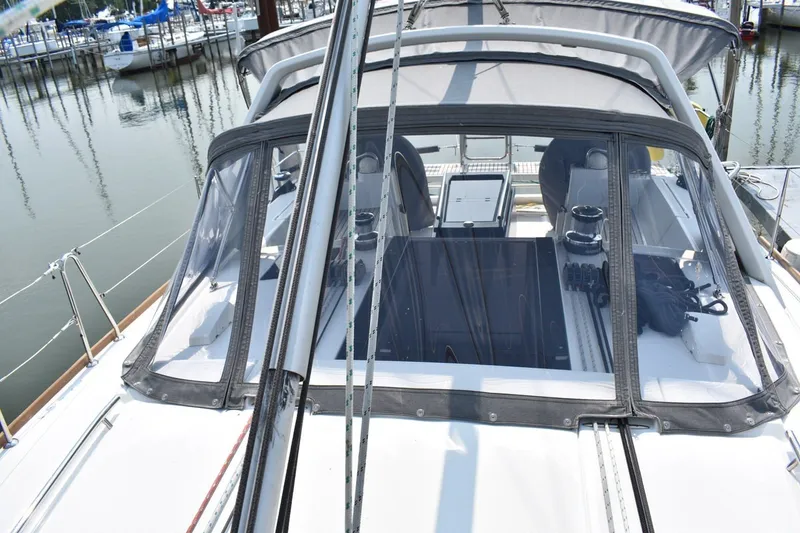 Slide: The Image of Beneteau Oceanis 41.1 sailboat cockpit with protective canopy, docked in a marina, 2012 model. - 26