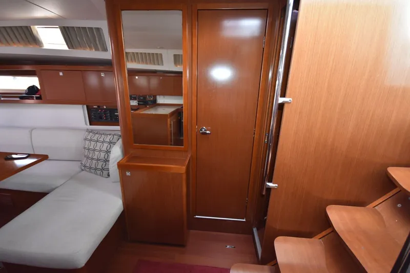 Slide: The Image of Interior of 2012 Beneteau Oceanis 41.1 yacht with wooden cabinetry and seating area. - 43