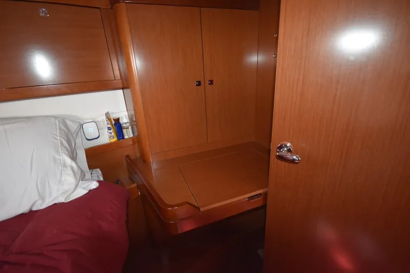 Slide: The Image of Interior cabin of 2012 Beneteau Oceanis 41.1 yacht with wooden cabinetry and bed. - 53