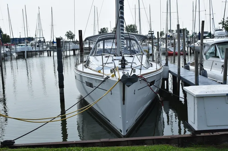 Slide: The Image of 2012 Beneteau Oceanis 41.1 yacht docked in a marina, surrounded by sailboats. - 2