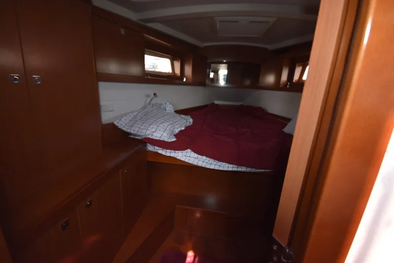 Slide: The Image of Interior cabin of 2012 Beneteau Oceanis 41.1 yacht with cozy bedding and wooden cabinetry. - 52