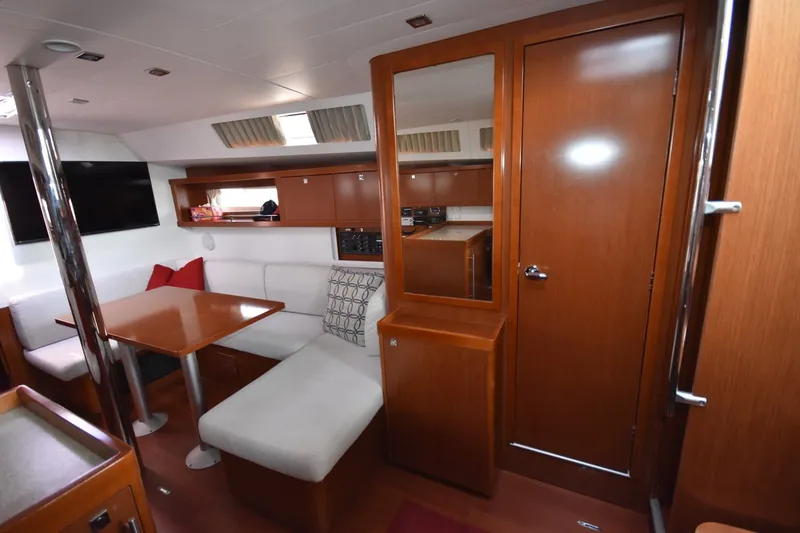 Slide: The Image of Interior of 2012 Beneteau Oceanis 41.1 yacht with cozy seating and wooden finishes. - 44