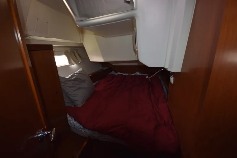 Slide: The Image of Cozy cabin interior of 2012 Beneteau Oceanis 41.1 sailboat with red bedding. - 50
