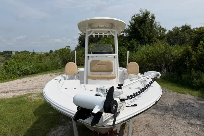 Slide: The Image of 2019 Sportsman Masters 227 Bay Boat on grassy terrain, featuring dual seats and a trolling motor. - 3