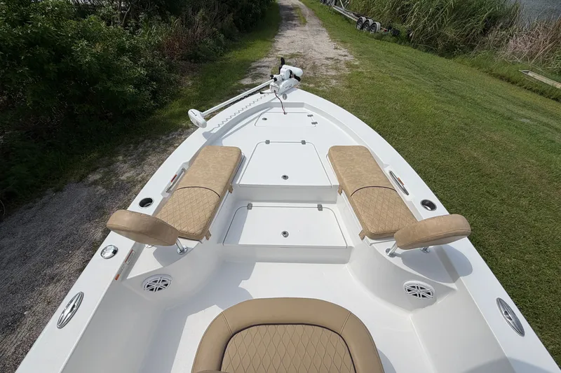 Slide: The Image of 2019 Sportsman Masters 227 Bay Boat with tan seating and spacious deck layout. - 11