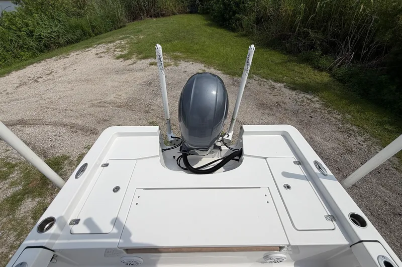 Slide: The Image of 2019 Sportsman Masters 227 Bay Boat with motor, viewed from above on grassy terrain. - 8