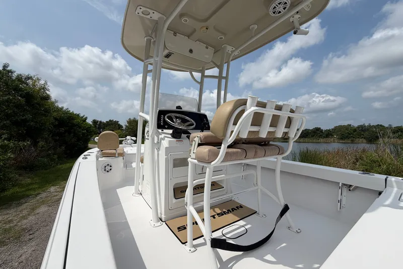 Slide: The Image of 2019 Sportsman Masters 227 Bay Boat with console and seating, set against a scenic backdrop. - 13