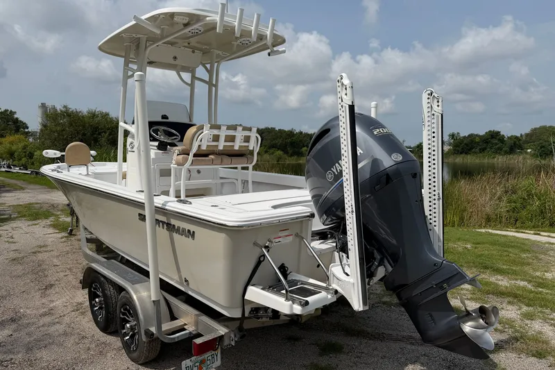 Slide: The Image of 2019 Sportsman Masters 227 Bay Boat with Yamaha engine on trailer, parked outdoors. - 5
