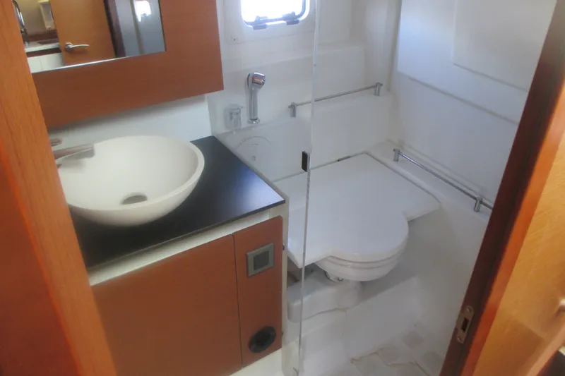 Slide: The Image of Modern bathroom in a 2016 Jeanneau Leader 36 yacht, featuring a sleek sink and compact toilet. - 26