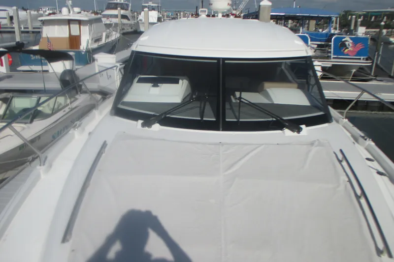 Slide: The Image of 2016 Jeanneau Leader 36 yacht docked at marina, front view with windshield and deck. - 7