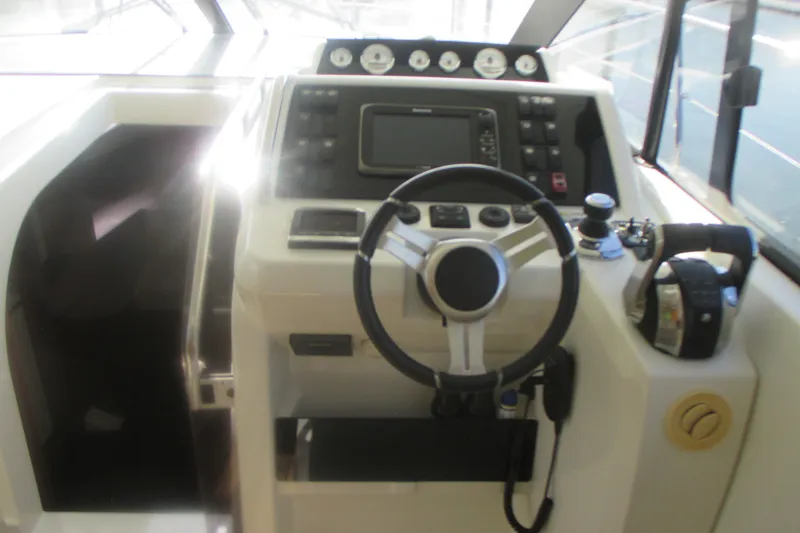 Slide: The Image of Cockpit of 2016 Jeanneau Leader 36 yacht with steering wheel and control panel. - 19