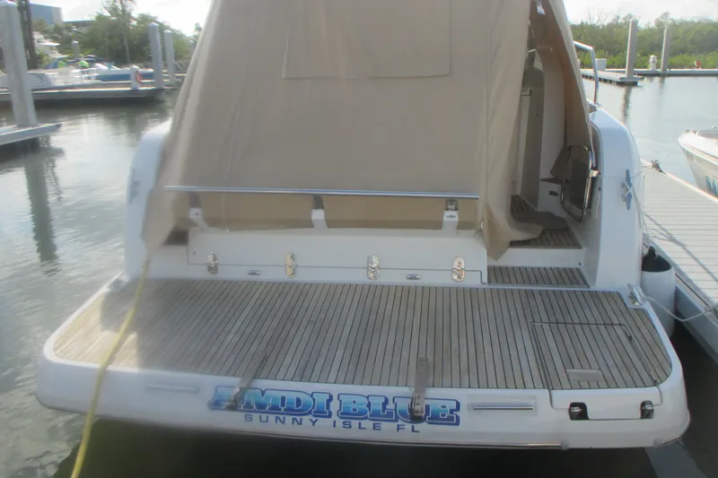 Slide: The Image of 2016 Jeanneau Leader 36 yacht docked, featuring teak swim platform and beige canvas cover. - 5