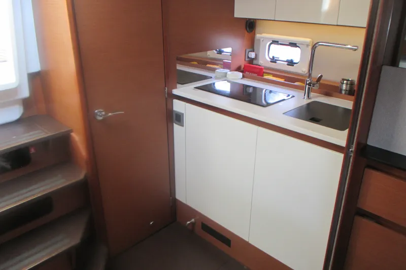 Slide: The Image of Compact kitchen area in a 2016 Jeanneau Leader 36 yacht, featuring modern amenities. - 24