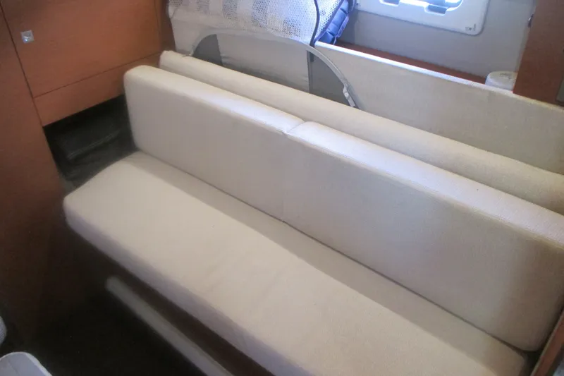 Slide: The Image of Interior seating area of a 2016 Jeanneau Leader 36 yacht, featuring beige upholstery. - 29