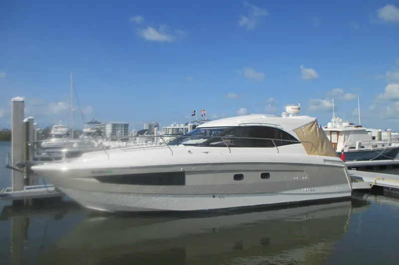 The Image of 2016 Jeanneau Leader 36 yacht docked at marina under clear blue sky. - 0