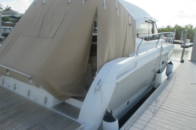 Slide: The Image of 2016 Jeanneau Leader 36 yacht docked with protective cover, side view. - 4
