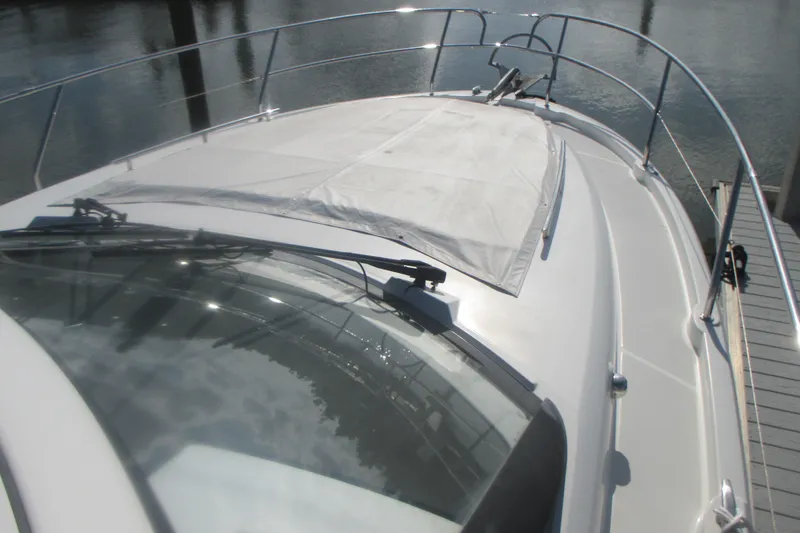 Slide: The Image of 2016 Jeanneau Leader 36 yacht deck with railing and sunshade, docked at marina. - 6