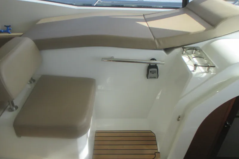 Slide: The Image of Interior seating area of a 2016 Jeanneau Leader 36 yacht with beige cushions. - 16