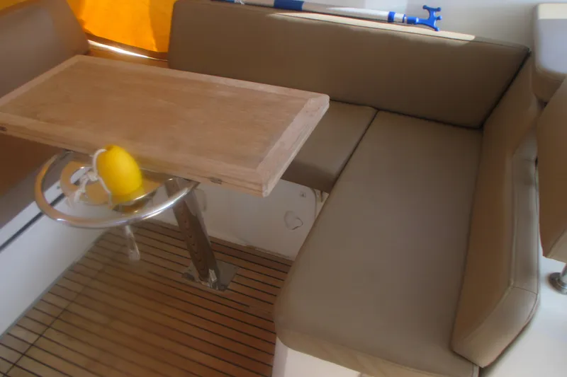 Slide: The Image of Interior seating area of 2016 Jeanneau Leader 36 yacht with wooden table. - 11