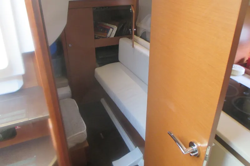 Slide: The Image of Interior cabin of 2016 Jeanneau Leader 36 yacht, featuring cozy seating and wooden finishes. - 27
