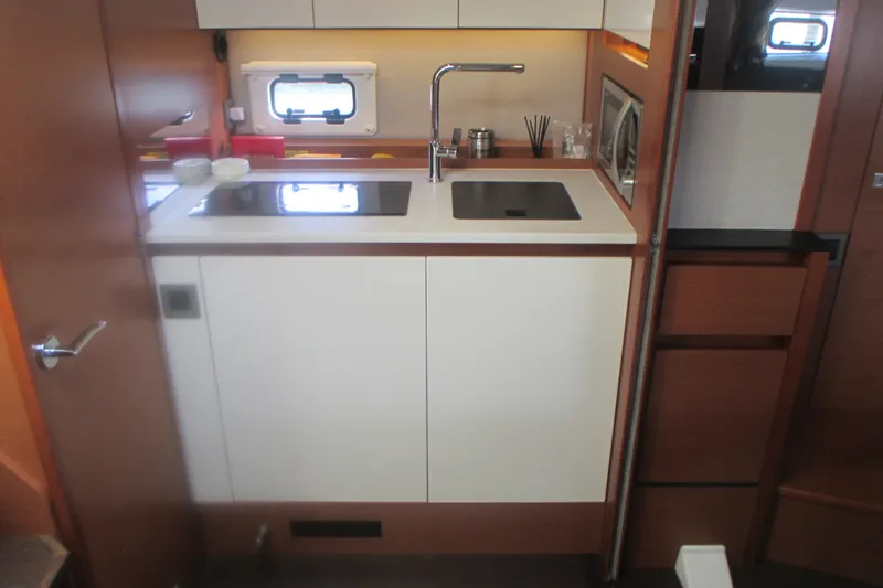 Slide: The Image of Compact kitchen area in a 2016 Jeanneau Leader 36 yacht, featuring modern amenities. - 22
