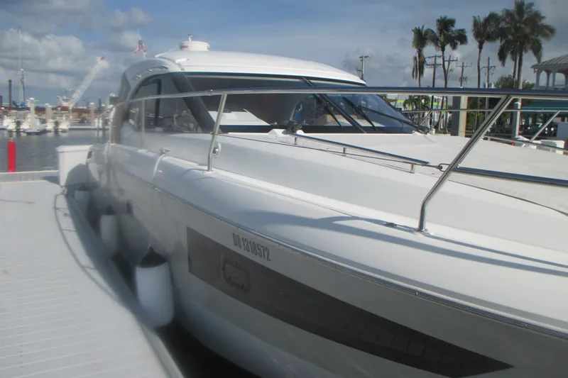Slide: The Image of 2016 Jeanneau Leader 36 yacht docked at marina with clear skies and palm trees. - 3