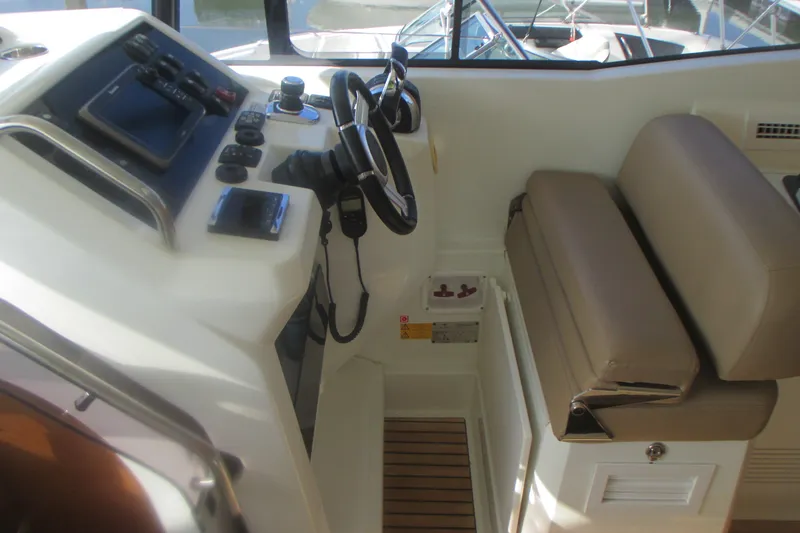 Slide: The Image of Cockpit of 2016 Jeanneau Leader 36 with steering wheel and control panel. - 18