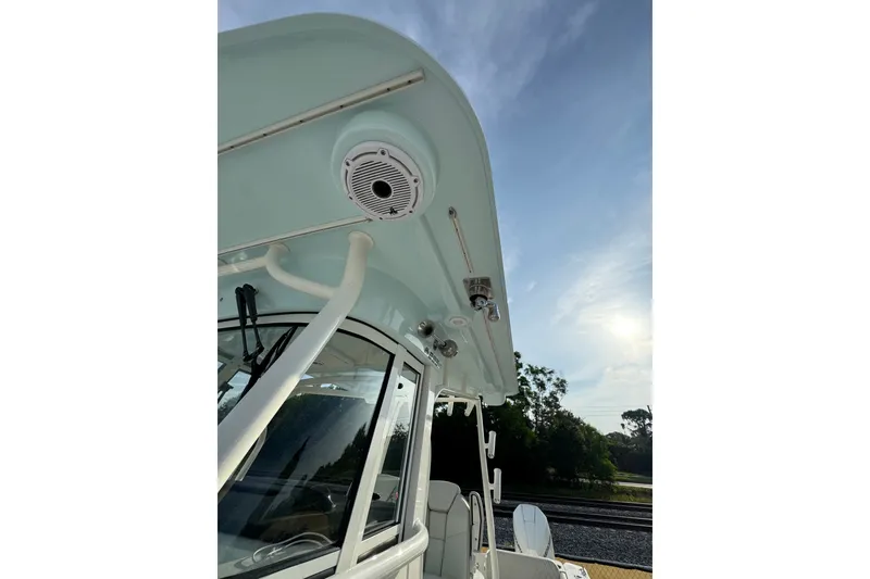 Slide: The Image of 2026 World Cat 295 CC boat with sleek design and modern features under a clear sky. - 17