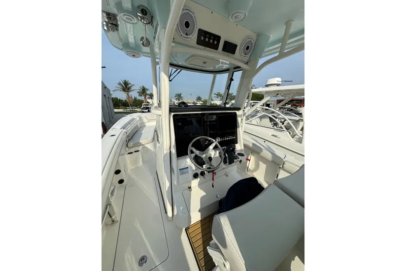 Slide: The Image of 2026 World Cat 295 CC boat cockpit with modern controls and seating. - 11
