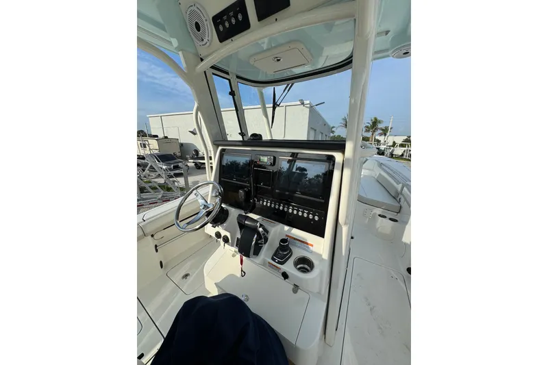 Slide: The Image of 2026 World Cat 295 CC boat cockpit with modern controls and steering wheel. - 9