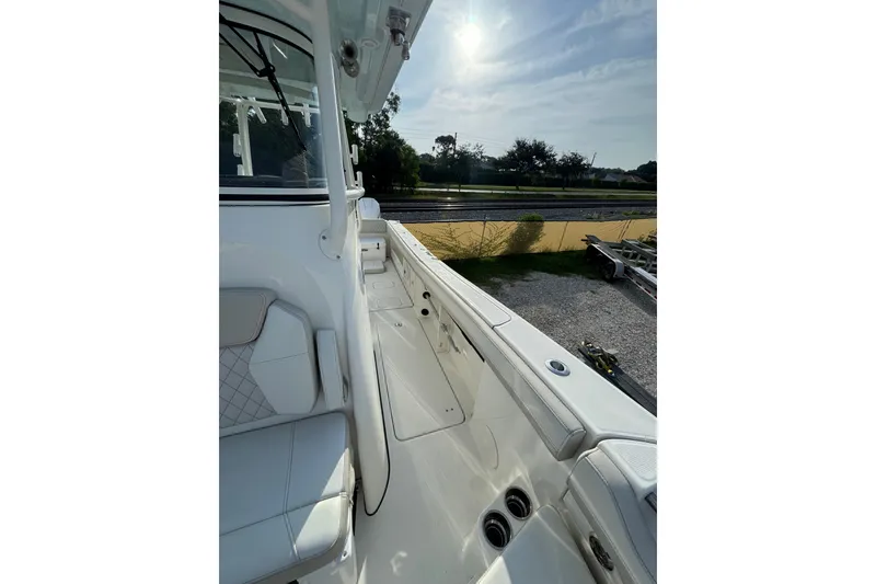 Slide: The Image of 2026 World Cat 295 CC boat interior with white seating and sleek design. - 6