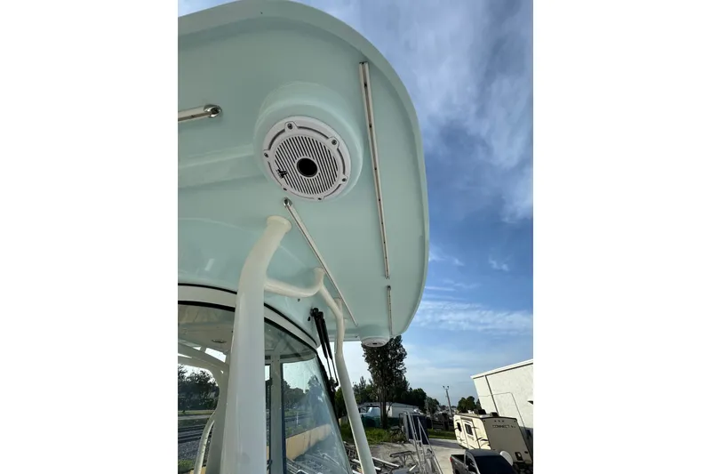 Slide: The Image of 2026 World Cat 295 CC boat roof with speaker and clear sky background. - 16