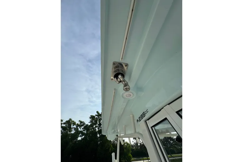 Slide: The Image of 2026 World Cat 295 CC boat detail, featuring a mounted fixture under a clear sky. - 15