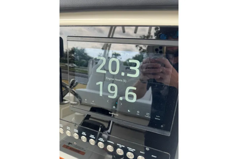 Slide: The Image of Display screen on 2026 World Cat 295 CC showing engine hours: 20.3 and 19.6. - 18