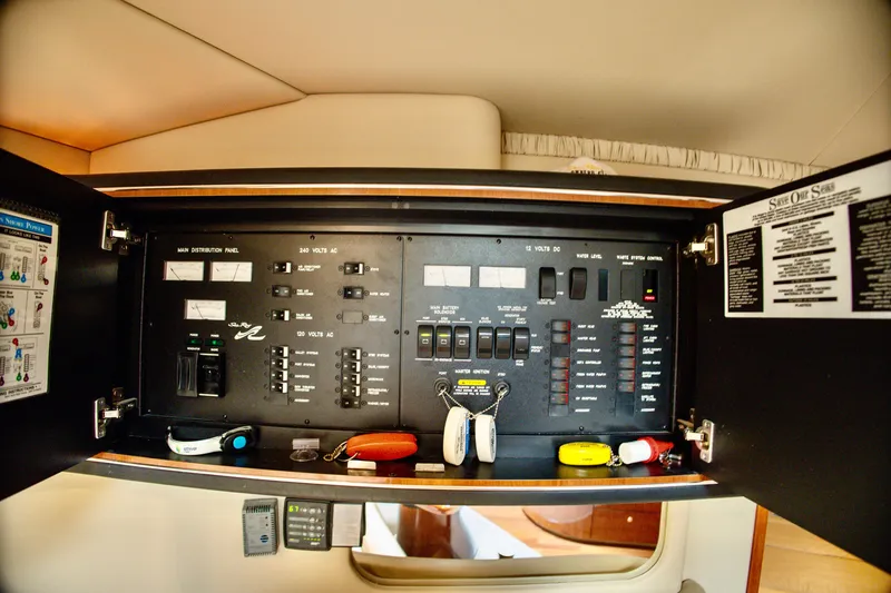 Slide: The Image of The image shows the electrical panel of a 2003 Sea Ray Sundancer 460 with various switches and indicators. - 27