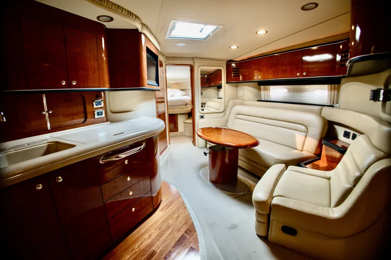 Slide: The Image of Interior of a 2003 Sea Ray Sundancer 460 with elegant wood furnishings and beige upholstery. - 14