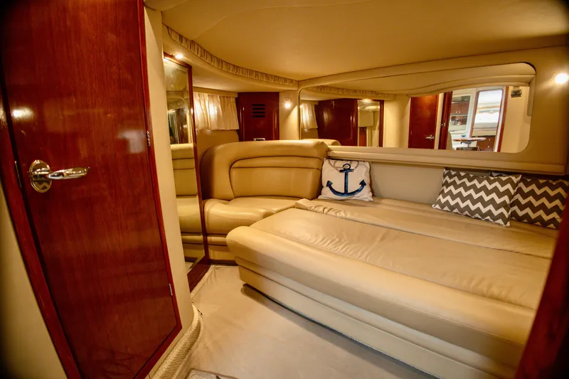 Slide: The Image of The image shows the interior of a 2003 Sea Ray Sundancer 460 with beige leather sofas. - 23