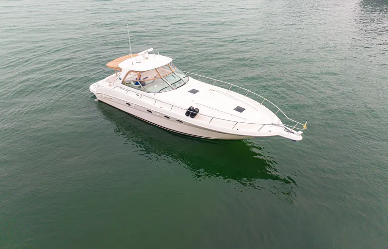 Slide: The Image of A white 2003 Sea Ray Sundancer 460 floats on calm water. - 2