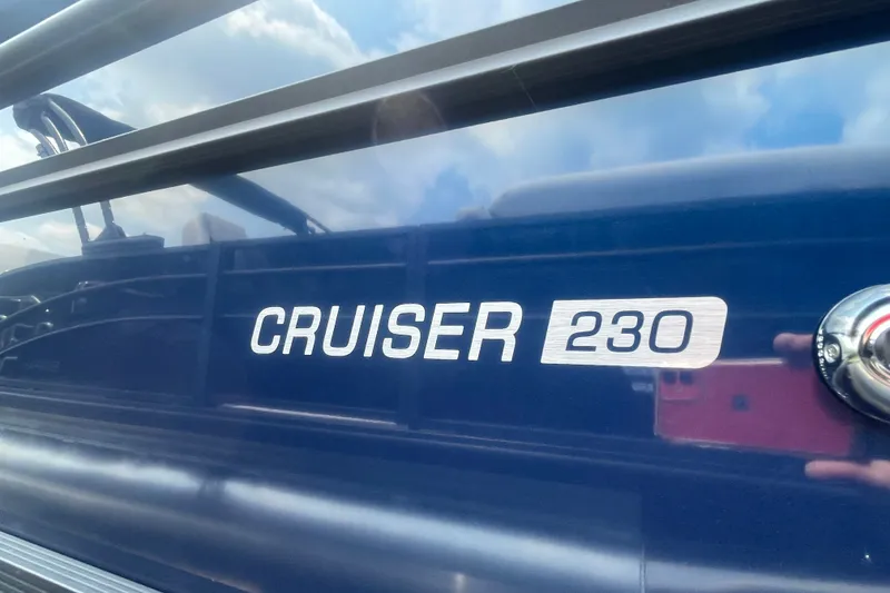 Slide: The Image of 2026 Harris Cruiser 230 SLDH boat nameplate with reflective surface. - 20
