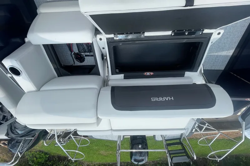 Slide: The Image of 2026 Harris Cruiser 230 SLDH boat interior with white seating and storage compartments. - 15