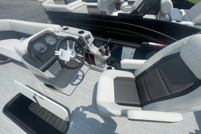 Slide: The Image of 2026 Harris Cruiser 230 SLDH boat interior with steering console and seating. - 3