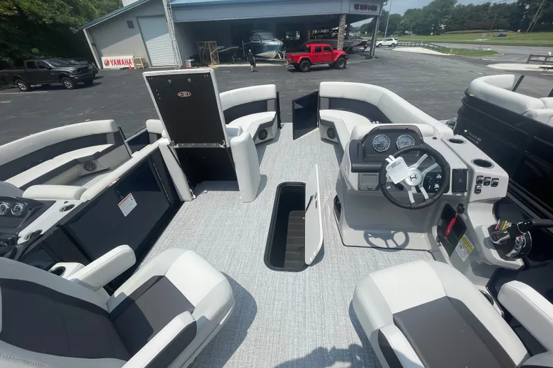 Slide: The Image of 2026 Harris Cruiser 230 SLDH pontoon boat interior with modern seating and steering console. - 2