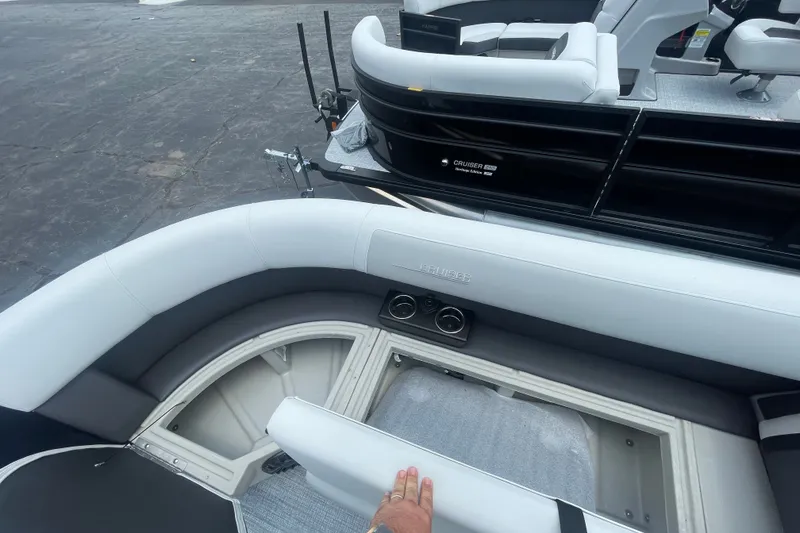 Slide: The Image of 2026 Harris Cruiser 230 SLDH boat interior with seating and storage compartment. - 14