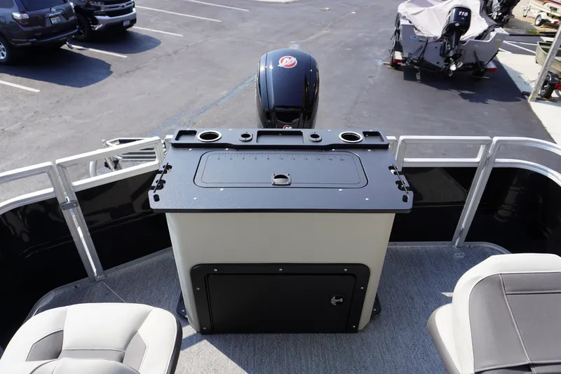 Slide: The Image of 2027 Sun Tracker Fishin' Barge 20 DLX with fishing station and motor, parked in a lot. - 13